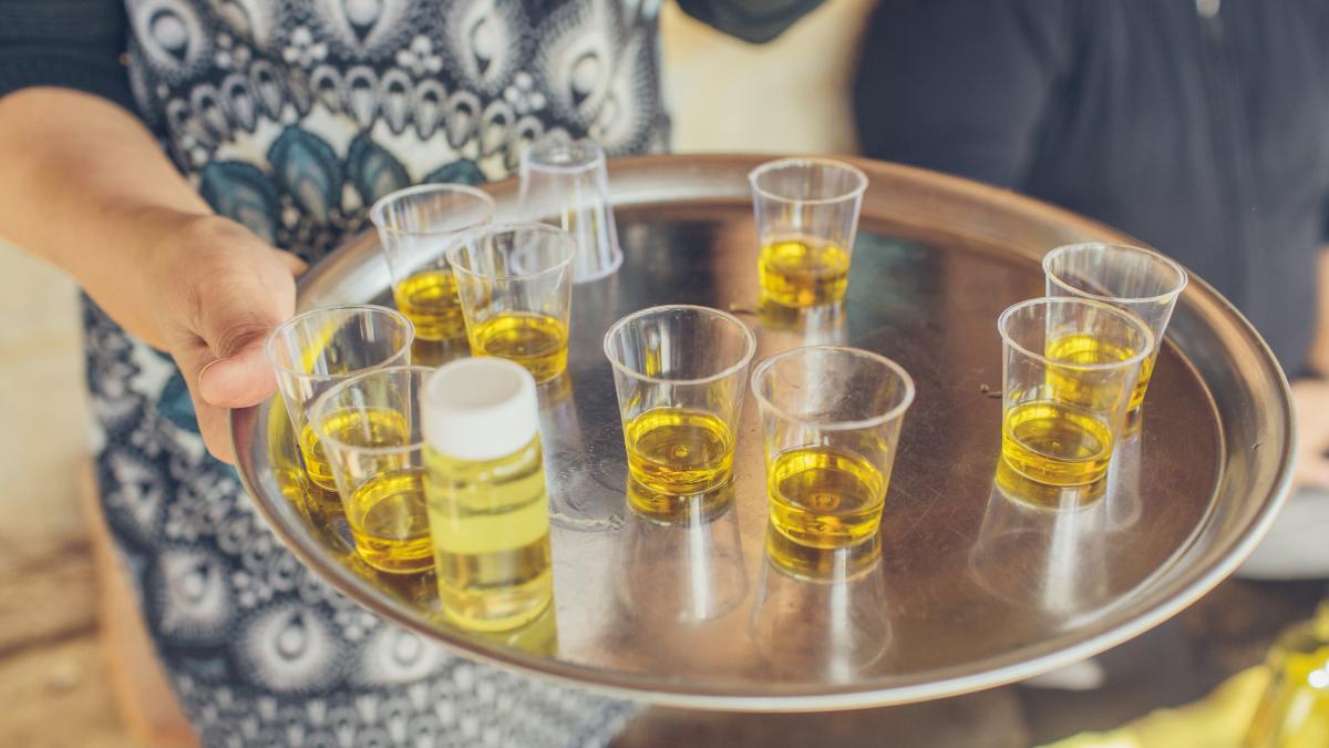 A tray of small glasses filled with olive oil.