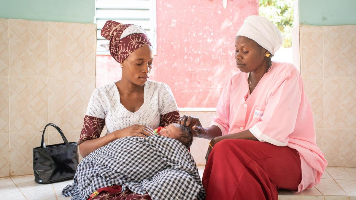 Djiba Balde sits with her child, Aissatou Balde, and the matron Penda Balde, after a consultation in the health center of Sarre Bilaly in the Kolda region, Senegal.
