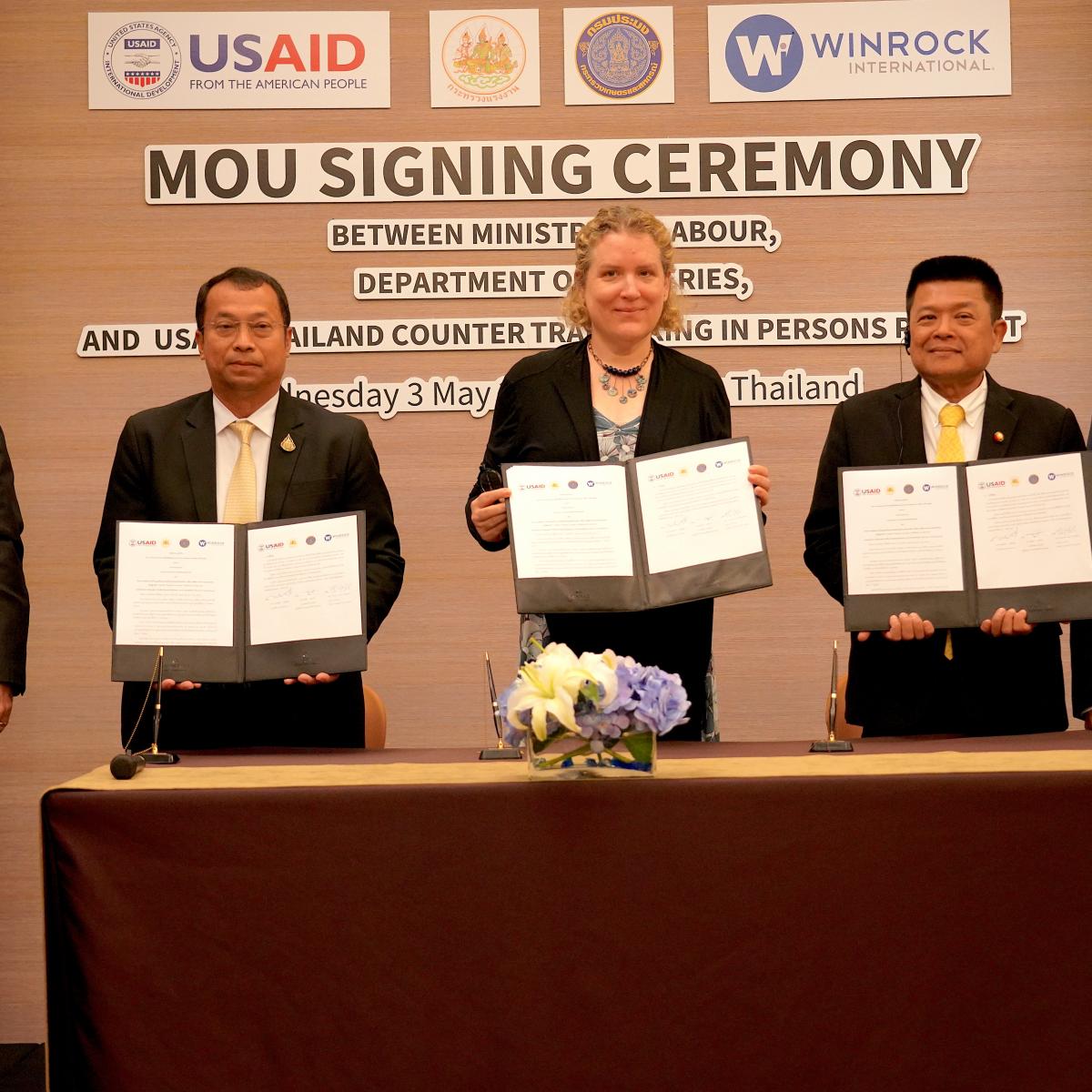 Photo of five people, three holding copies of the MOU and two, including USAID Asia Mission Director Dr. Steven G. Olive, standing on each side as witnesses.