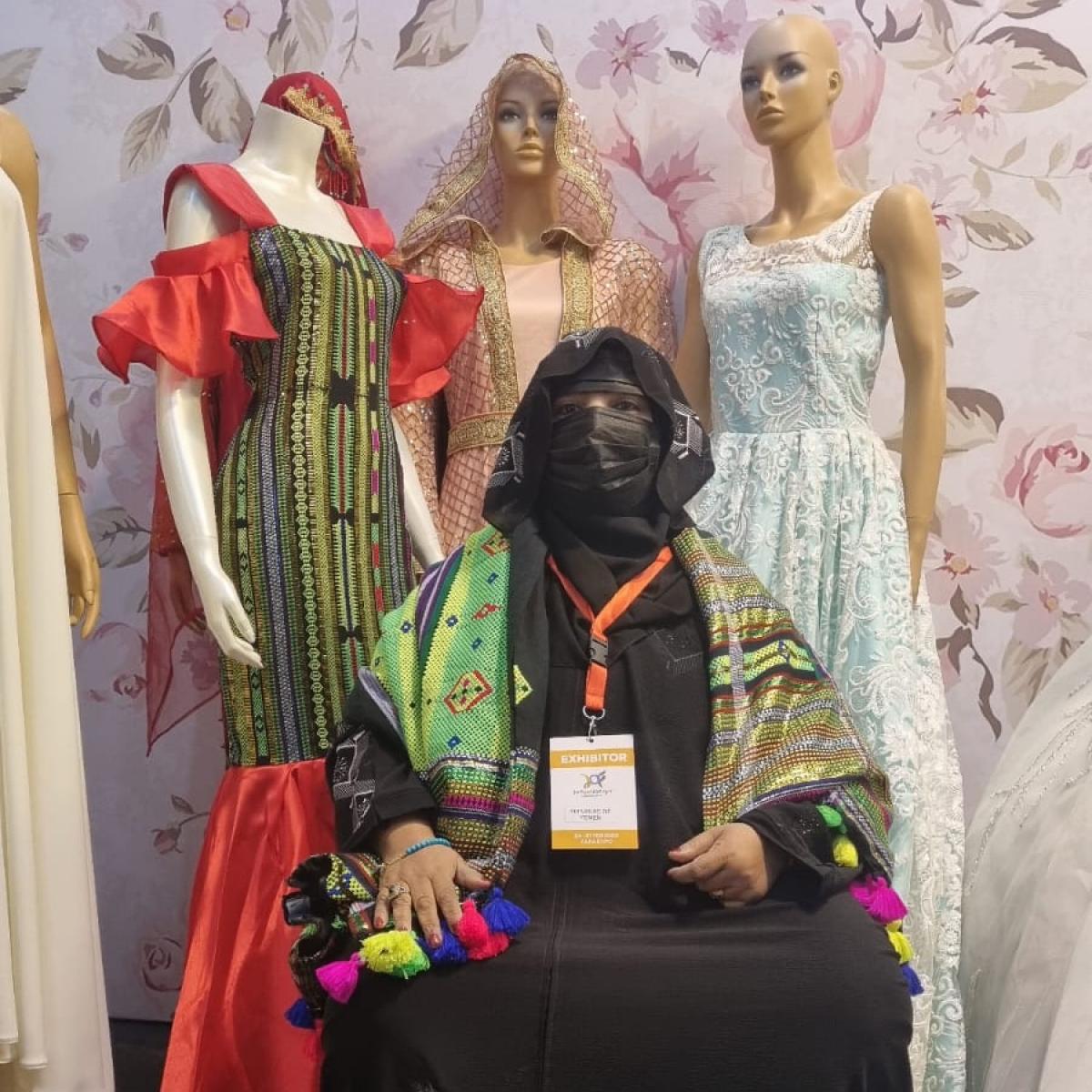 Fayza Salim Nany with some of her clothing products at the JO Fashion Expo in Amman, Jordan.