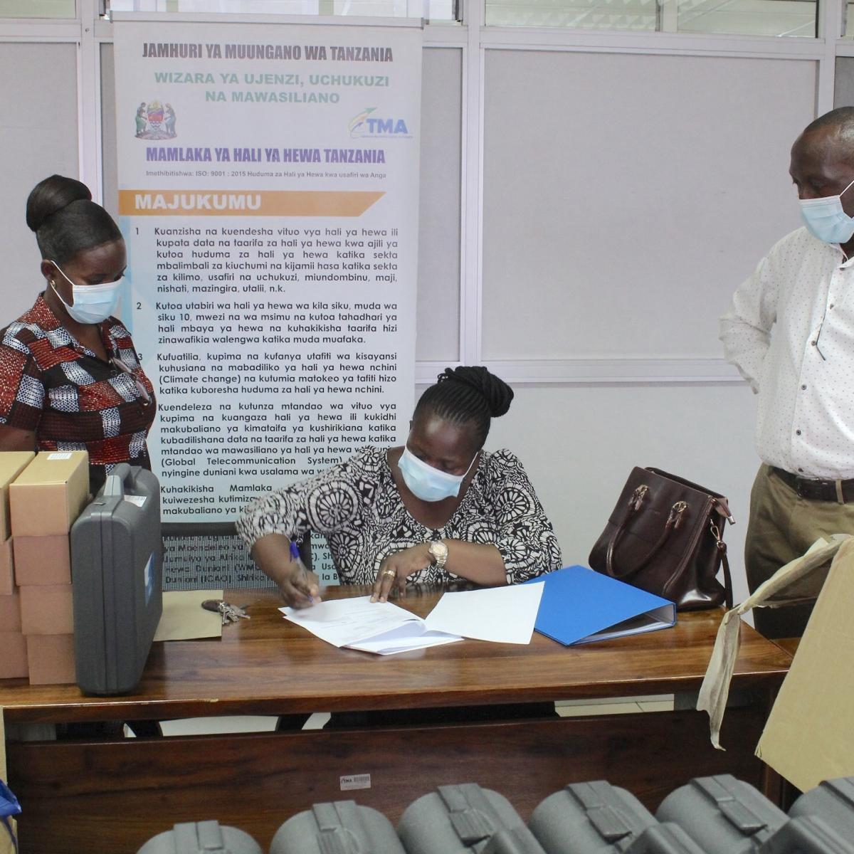 TMA’s Manager for Environment & Research Ms. Sarah Osima signs off on the official handover agrometeorological supplies with FAO’s National Project Coordinator Mr. Diomedes Kalisa (right) and In Country Coordinator Ms. Rebecca Mwasyoke of Washington State University International Development Office (left). Since 2015, USAID has funded the “Building Capacity for Resilient Food Security Project,” which provides technical assistance and funding to TMA.