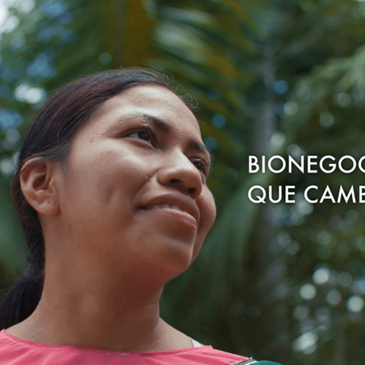 An indigenous woman staring optimistically in the Amazon rainforest