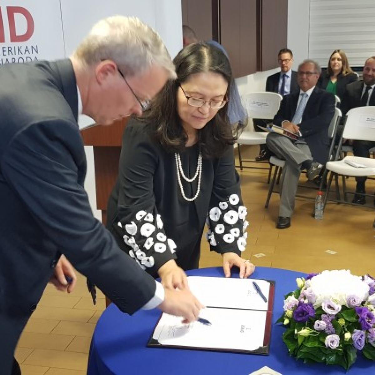 USAID Kosovo Swearing in Ceremony: Ambassador Delawie and Lisa Magno sign the Oath of Office