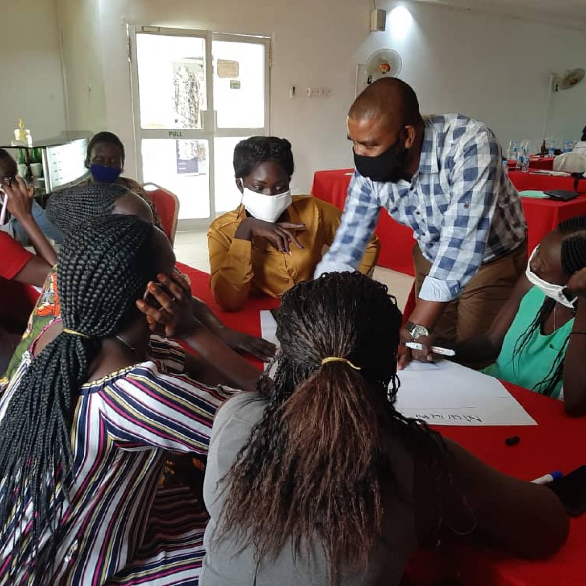 Kumbirai facilitating the DREAMS Facilitators' training & engaging in group work discussion, Aron Hotel, May 2021, Juba