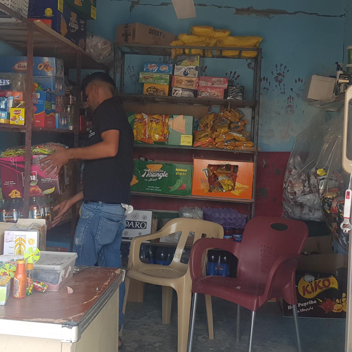 Marwan organizes his convenience store in Sinjar.