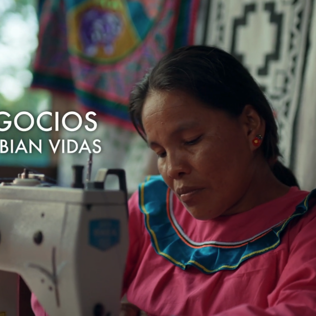 An indigenous woman using a sewing machine.