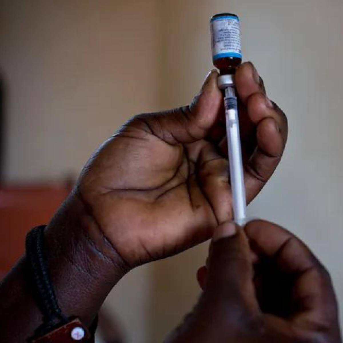 Person holding a malaria vaccine 