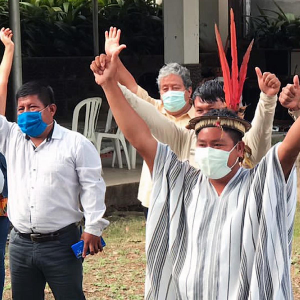 Members of Amazonian Indigenous community in La Convención, Cusco, raising hands and welcoming the Indigenous Task Force.