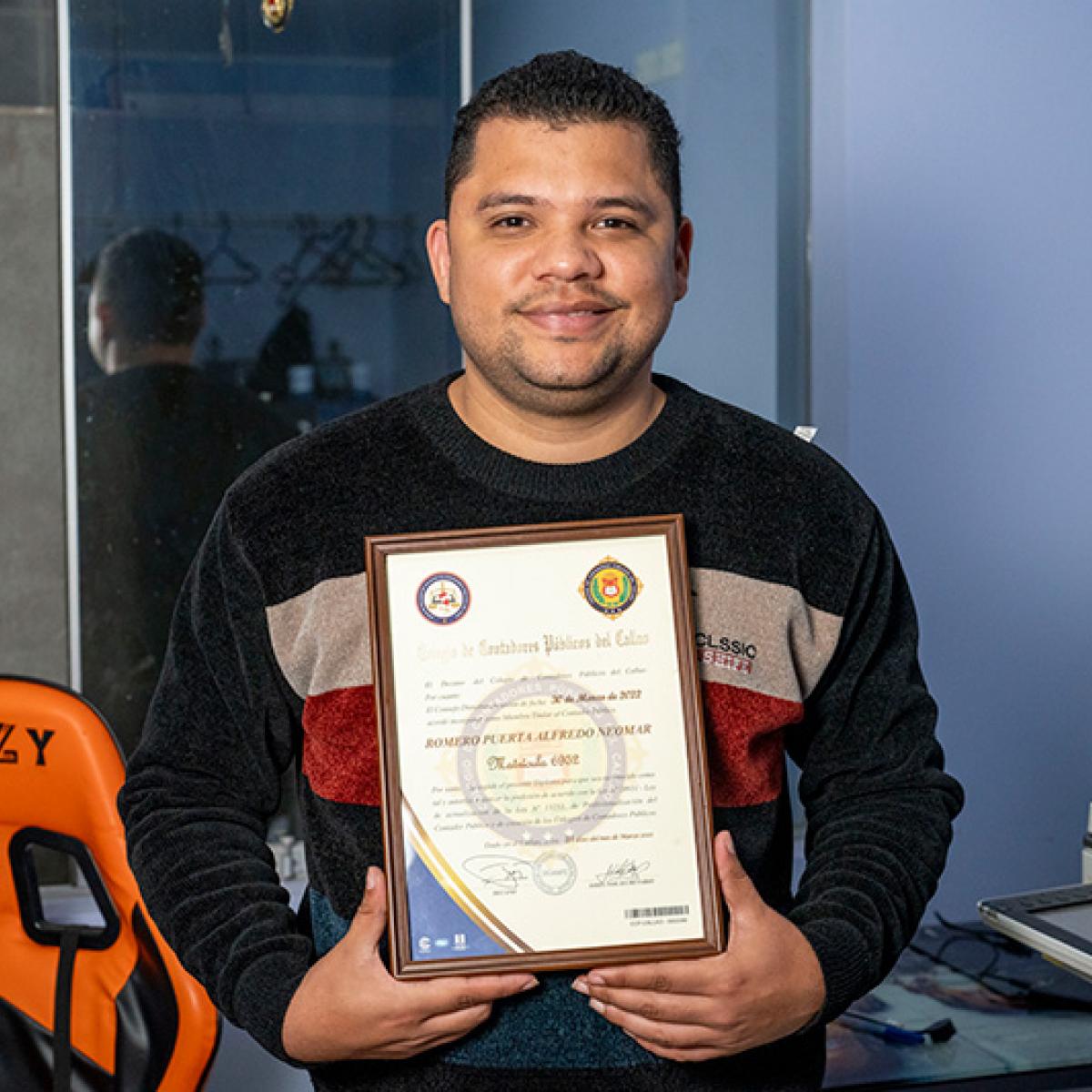 A man holding his public accountant diploma