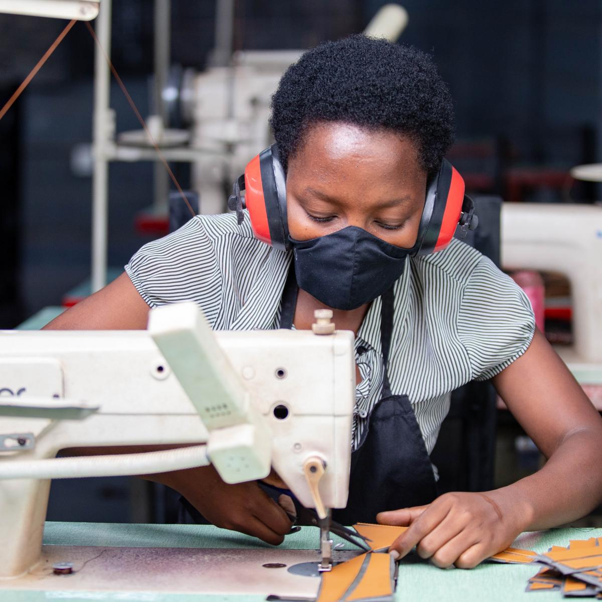 A female worker cuts leather at Uzuri K&Y’s workshop in Kigali, Rwanda. Uzuri K&Y Limited