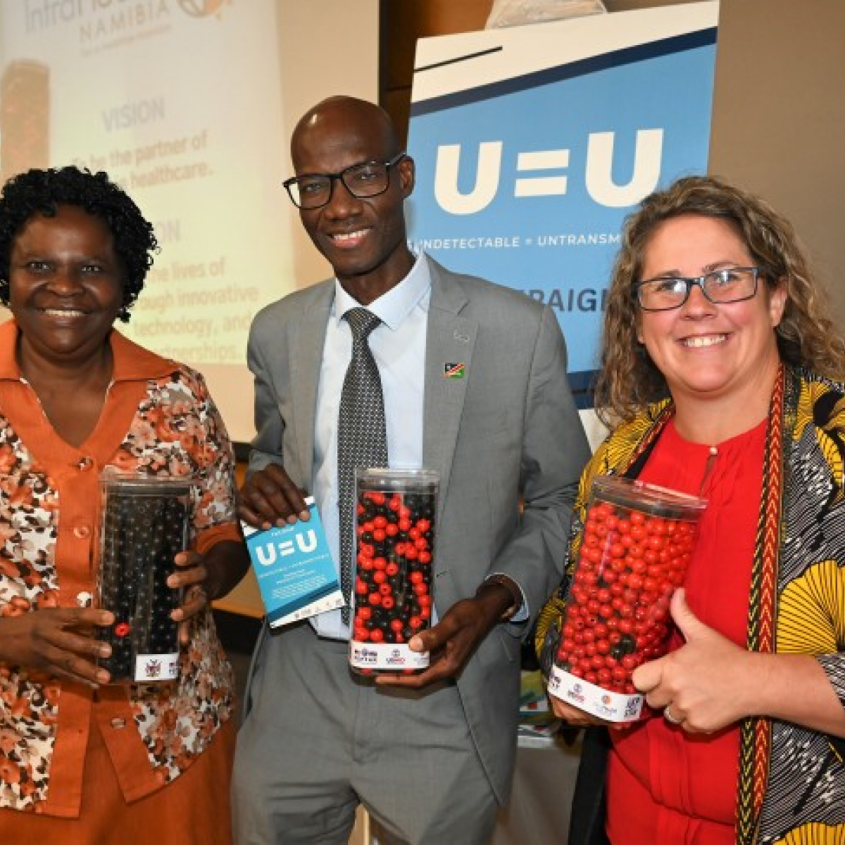 UNAIDS Namibia Director Dr. Alti Zwandor, Acting Health Ministry ED Jeremia Nghipundjwa and Acting USAID Namibia Representative Laura Muzart showcasing outreach tools that explain the meaning of “Undetectable = Untransmittable.”