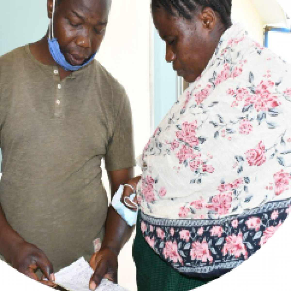 Pendo and husband on the morning of delivery looking over the list of required medicines and supplies.