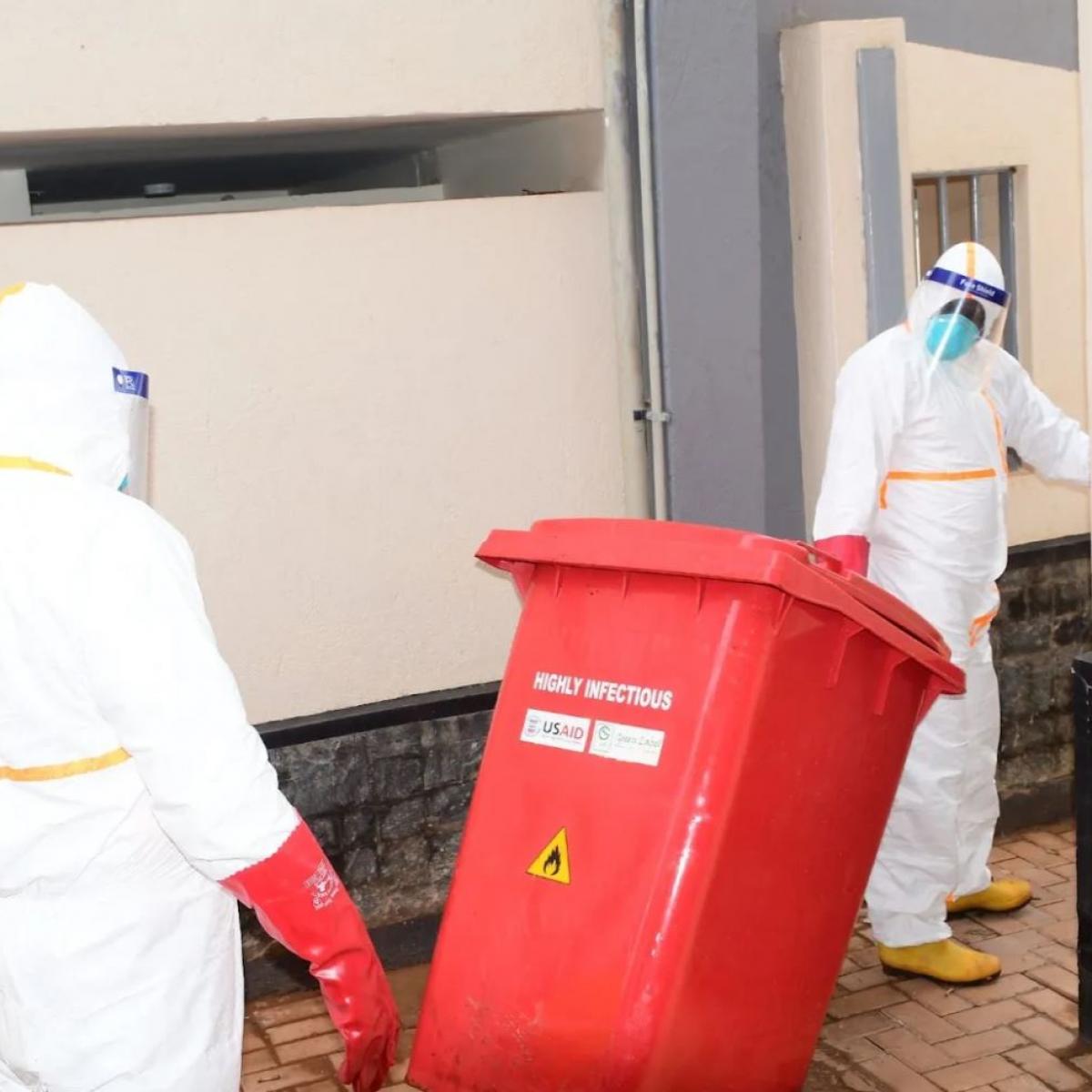Workers collect and dispose of highly infectious waste from the Ebola isolation unit at Mulago National Referral Hospital. / Green Label Services
