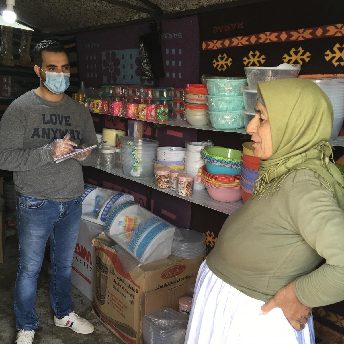 Kochari (right) and Farhan (left) live side-by-side in Kobarto 2 Camp near Dohuk. As their friendship grew, and with a little help from USAID, Kochari and Farhan now run a successful shop selling goods to other camp residents. 