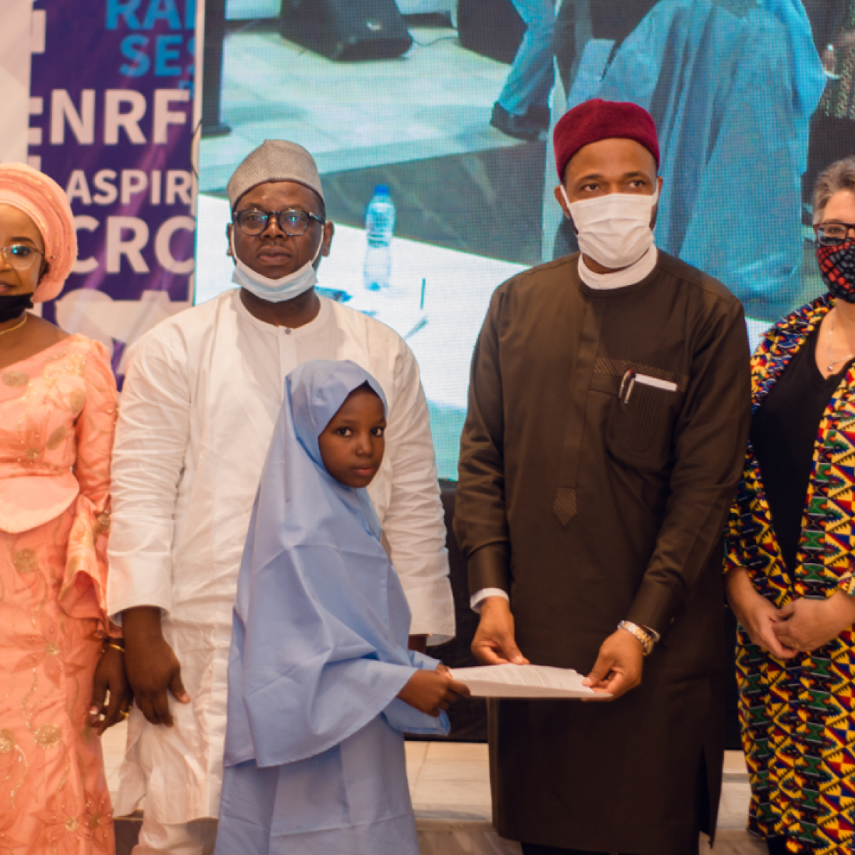 Minister of Education for State, Honorable Emeka Nwajiuba acknowledging the presentation from Aminatu Ammar a primary school pupil and beneficiary of the NEI Plus activity at the close-out ceremony in Abuja