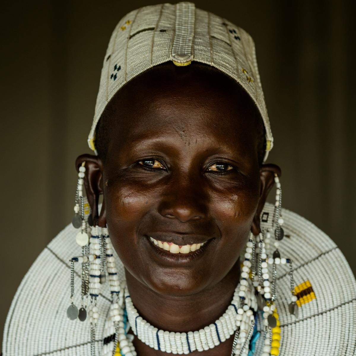 A Tanzanian woman wearing a large necklace.