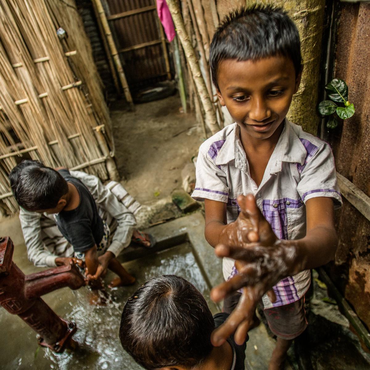 Children washing their hands.