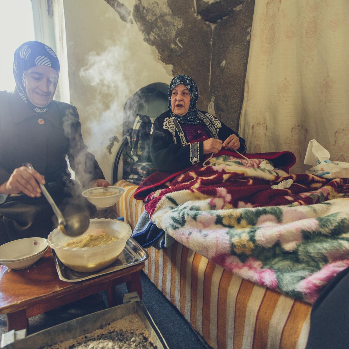 Women sharing a meal in a bedroom.
