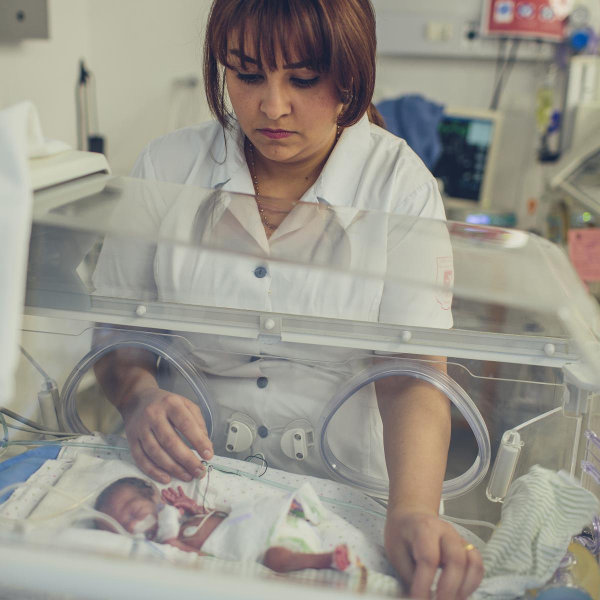 Nurse Rula tends to a baby in the NICU
