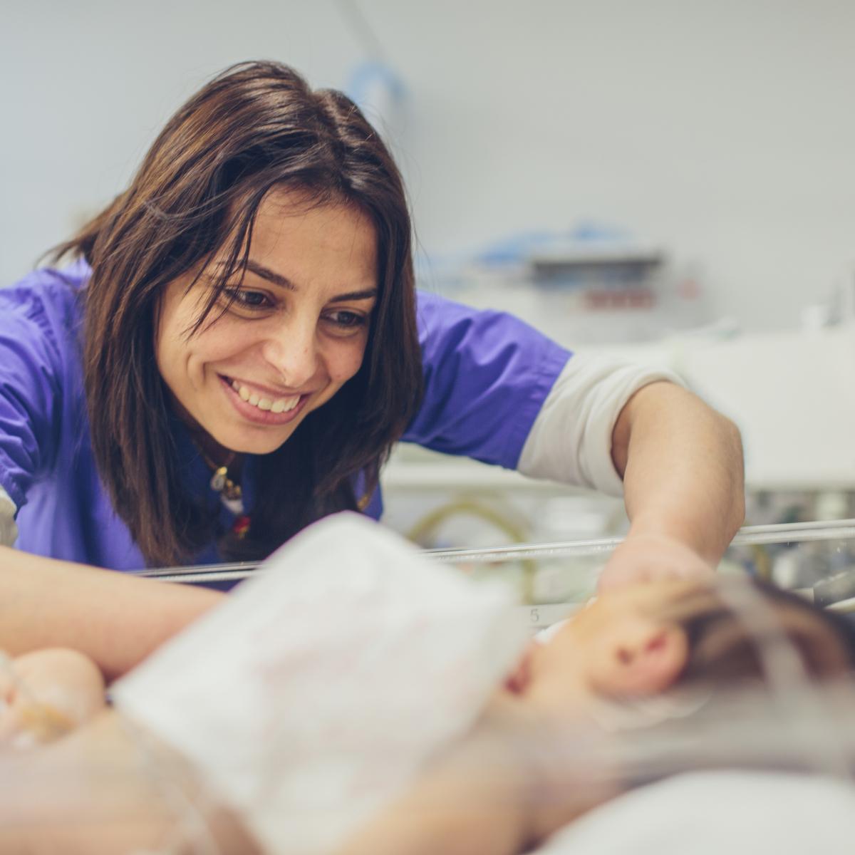 A doctor smiles at a baby