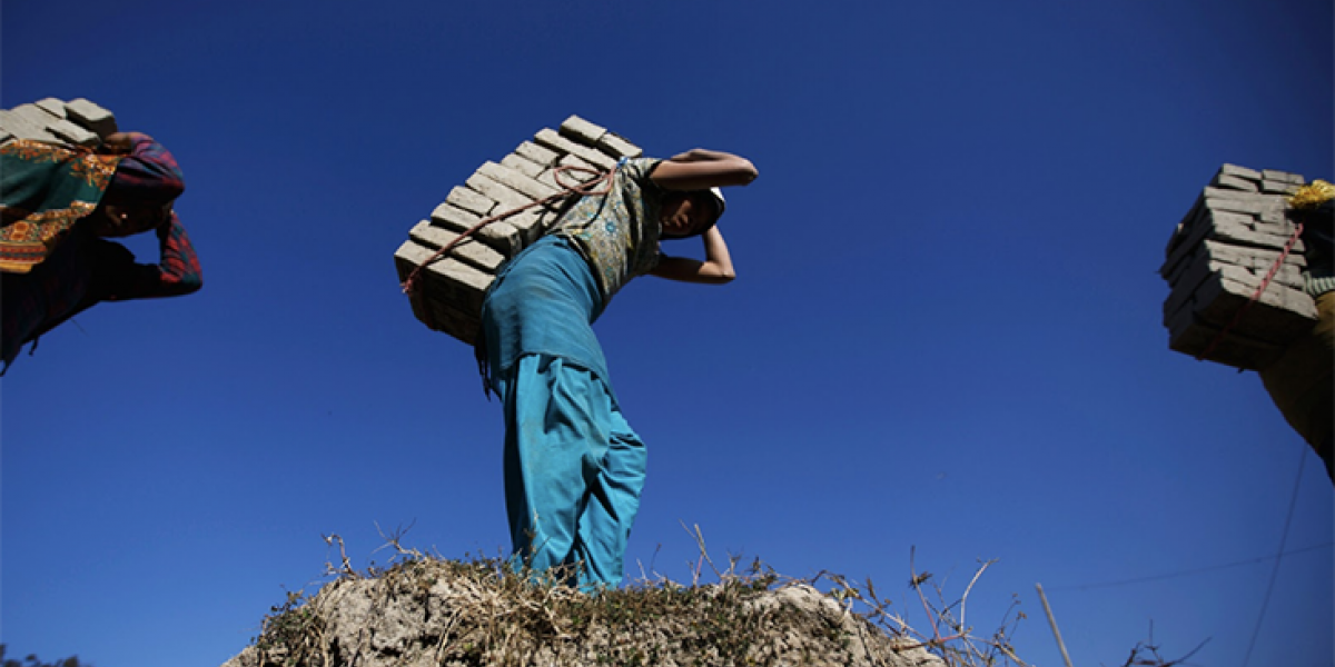 Human Trafficking, person carrying bricks