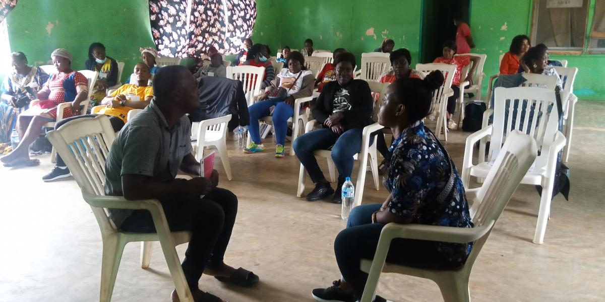 A healthcare provider (left) and a young woman (right) demonstrate using the Empathways cards during an interpersonal communication and counseling training in Grand Cape Mount County, Liberia.