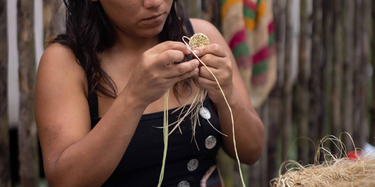 Indigenous woman working on handicrafts