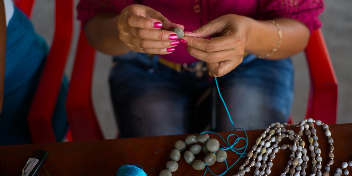 An up-close view of a woman's hands as she creates jewelry.
