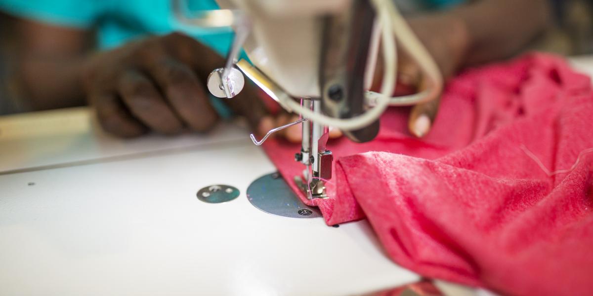 A closeup of a garment being sewn on a machine.