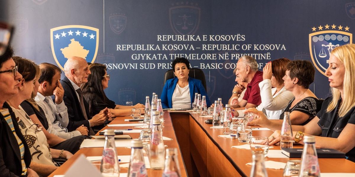Afërdita Bytyqi sits at the head of a board room table