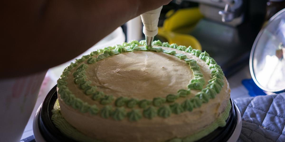 Close up of a cake being decorated.