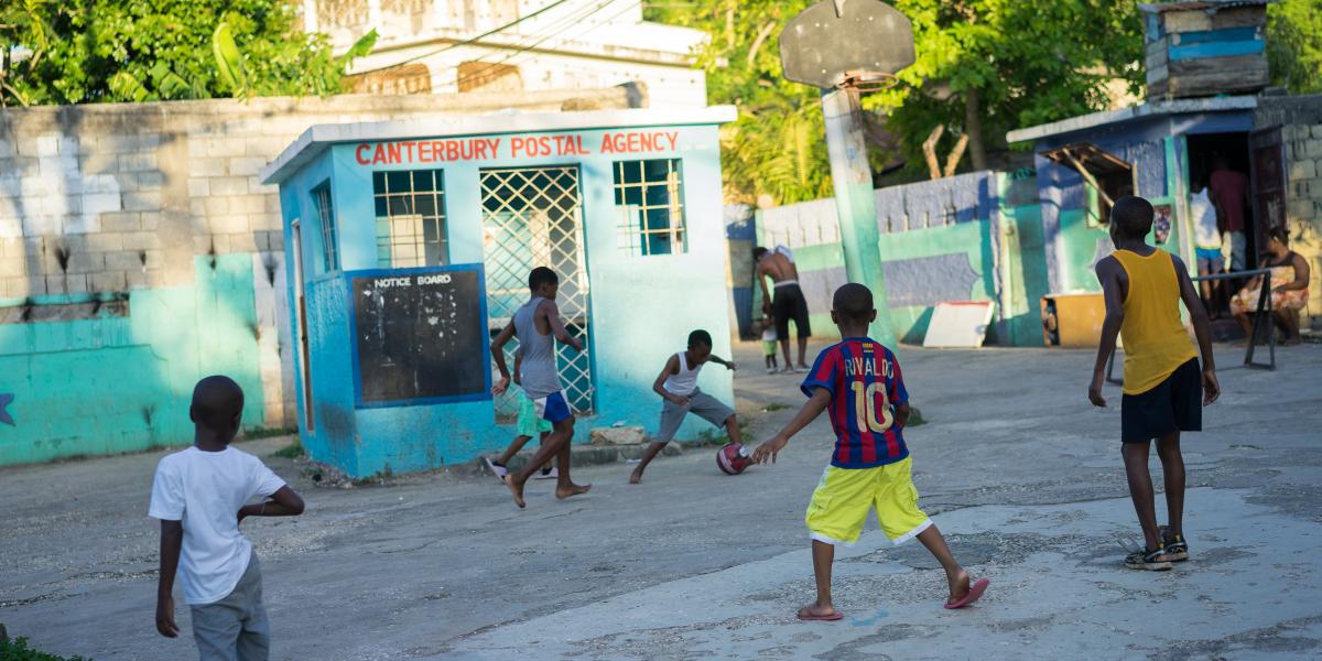 A group of children play a game of soccer.