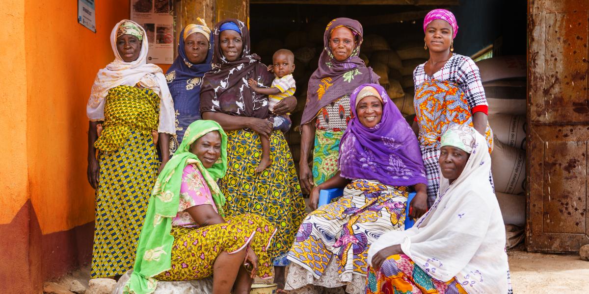 A group of women poses outside a building in Ghana.
