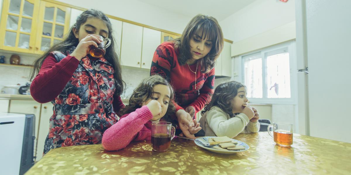 Rula serves breakfast to her daughters