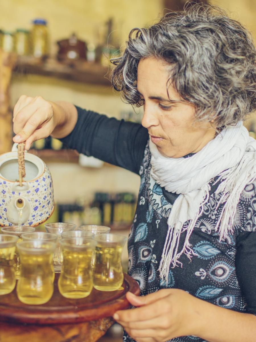 Ayala pours olive oil into several small glasses.