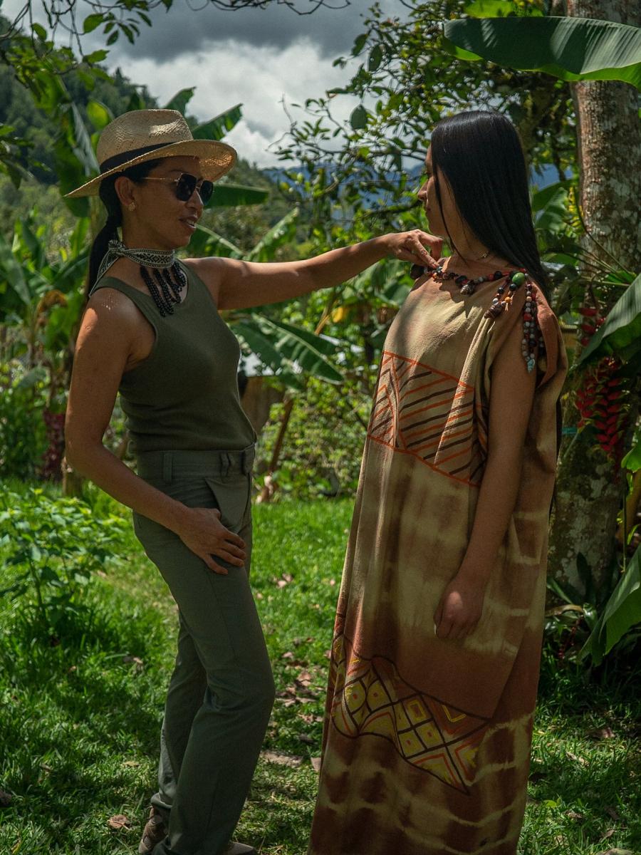 Peruvian fashion designer, Sumy Kujon, inspects a traditional Yanesha garment worn by a model. 