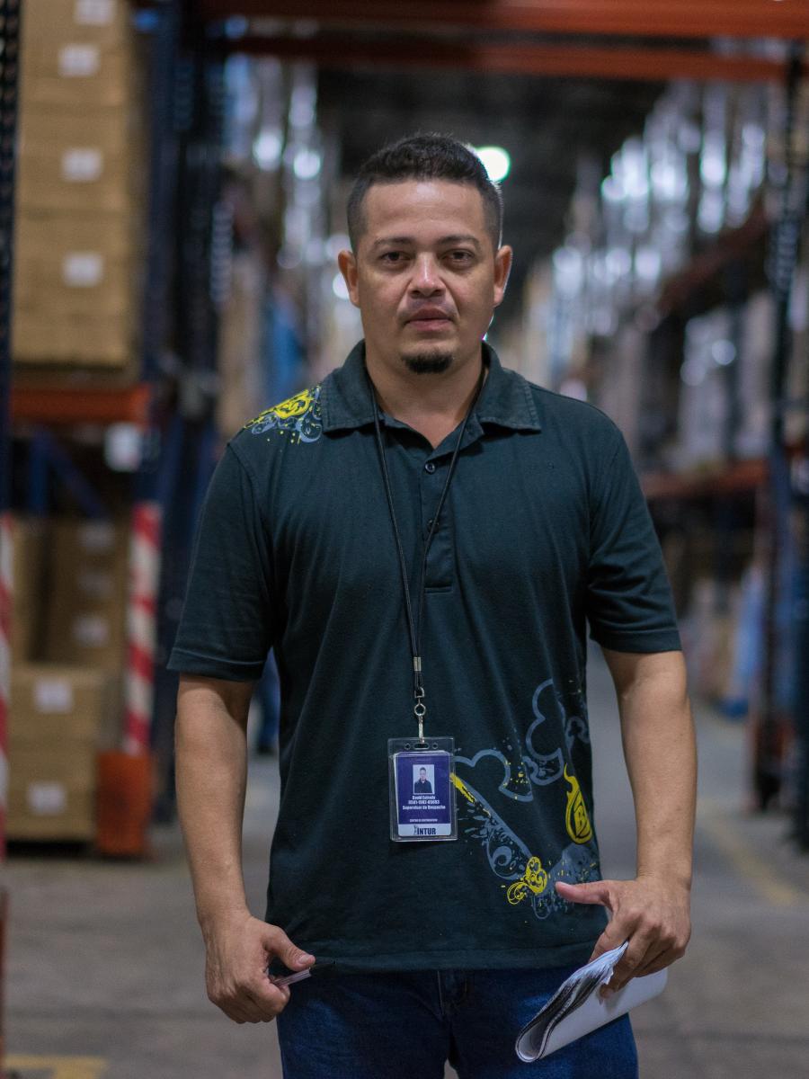 A man standing in a warehouse.