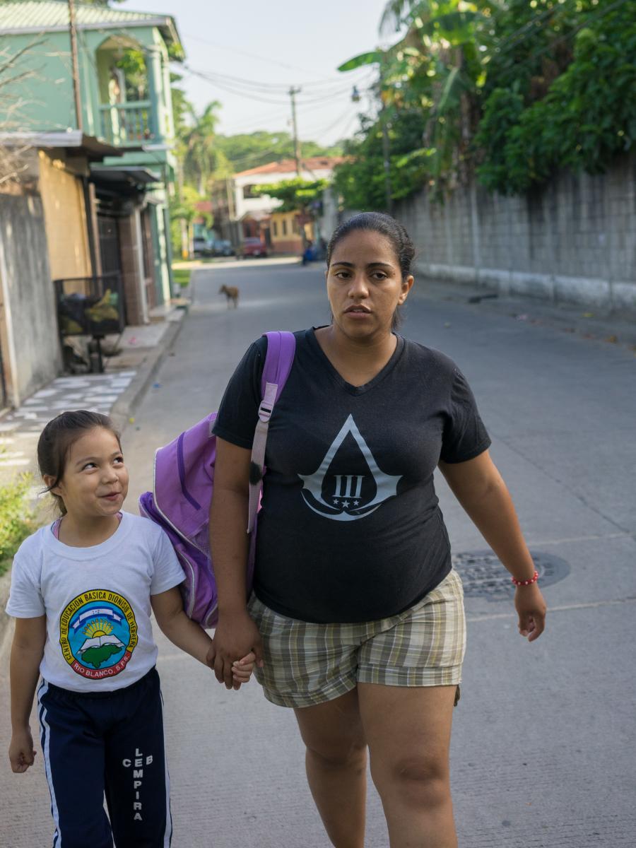 A mother and daughter walking together.