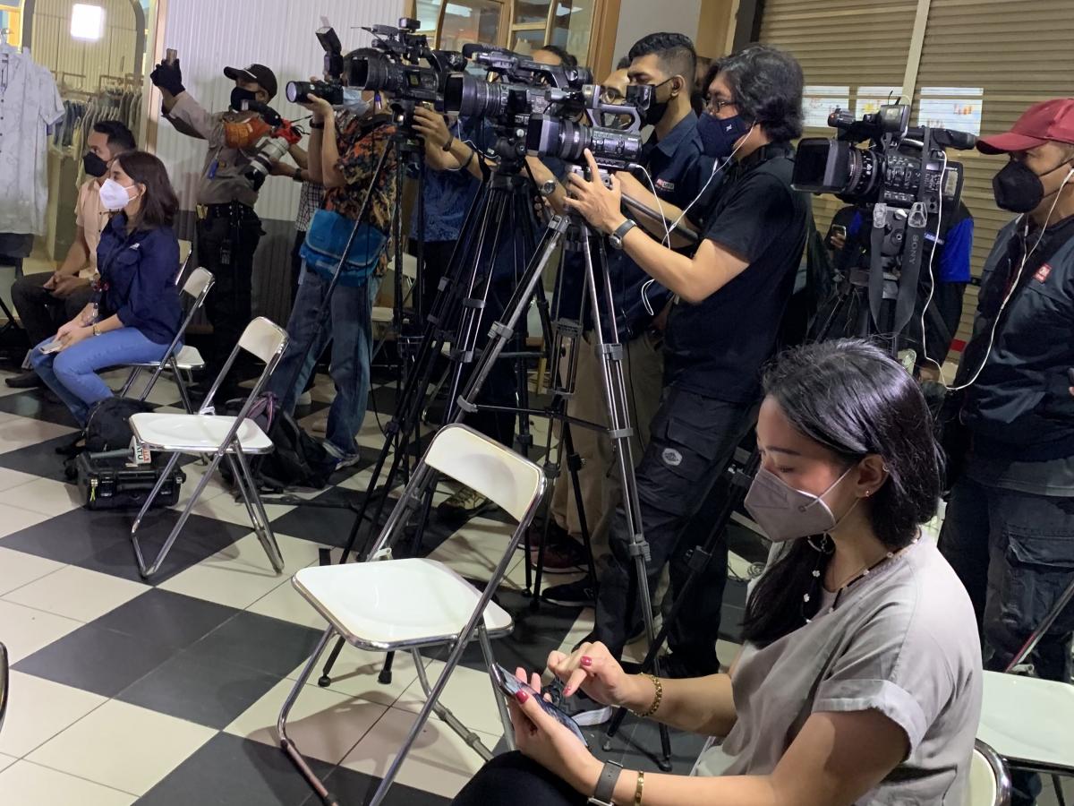 Journalists covering a press conference.