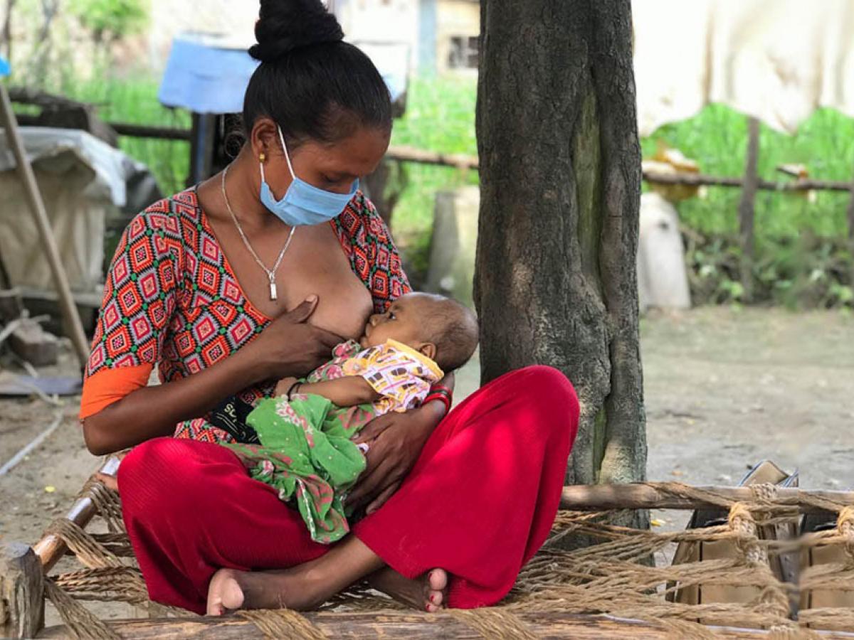 A woman breastfeeds her child