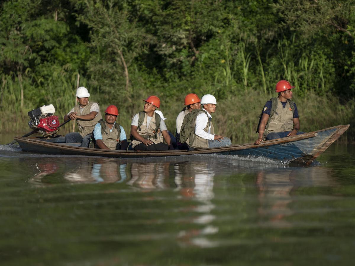 Indigenous People travel by boat on the Peruvian Amazon as part of USAID Forest Alliance’s communal forest management.