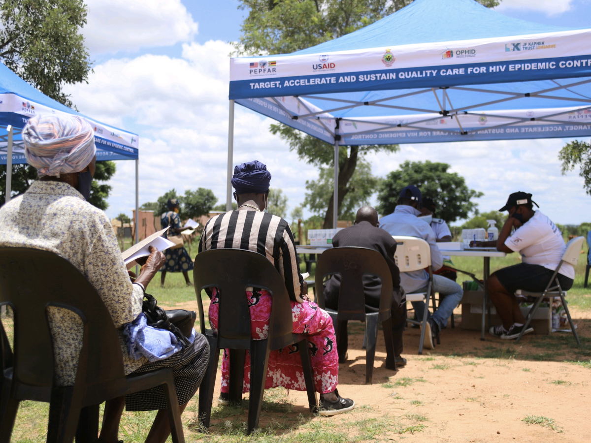 Clients wait for services during a community outreach event in Bulilima