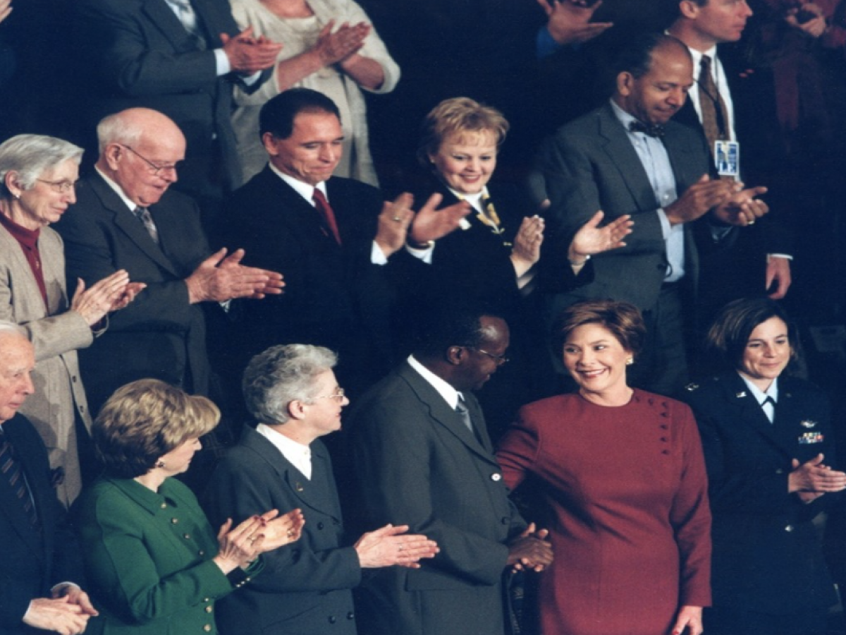 January 28, 2003, Laura Bush and Prof. Peter Mugyenyi (former JCRC Executive Director) at the State of the Union Address, US Capitol. In his speech, President Bush asked Congress to commit $15 billion for the fight against HIV/AIDS.
