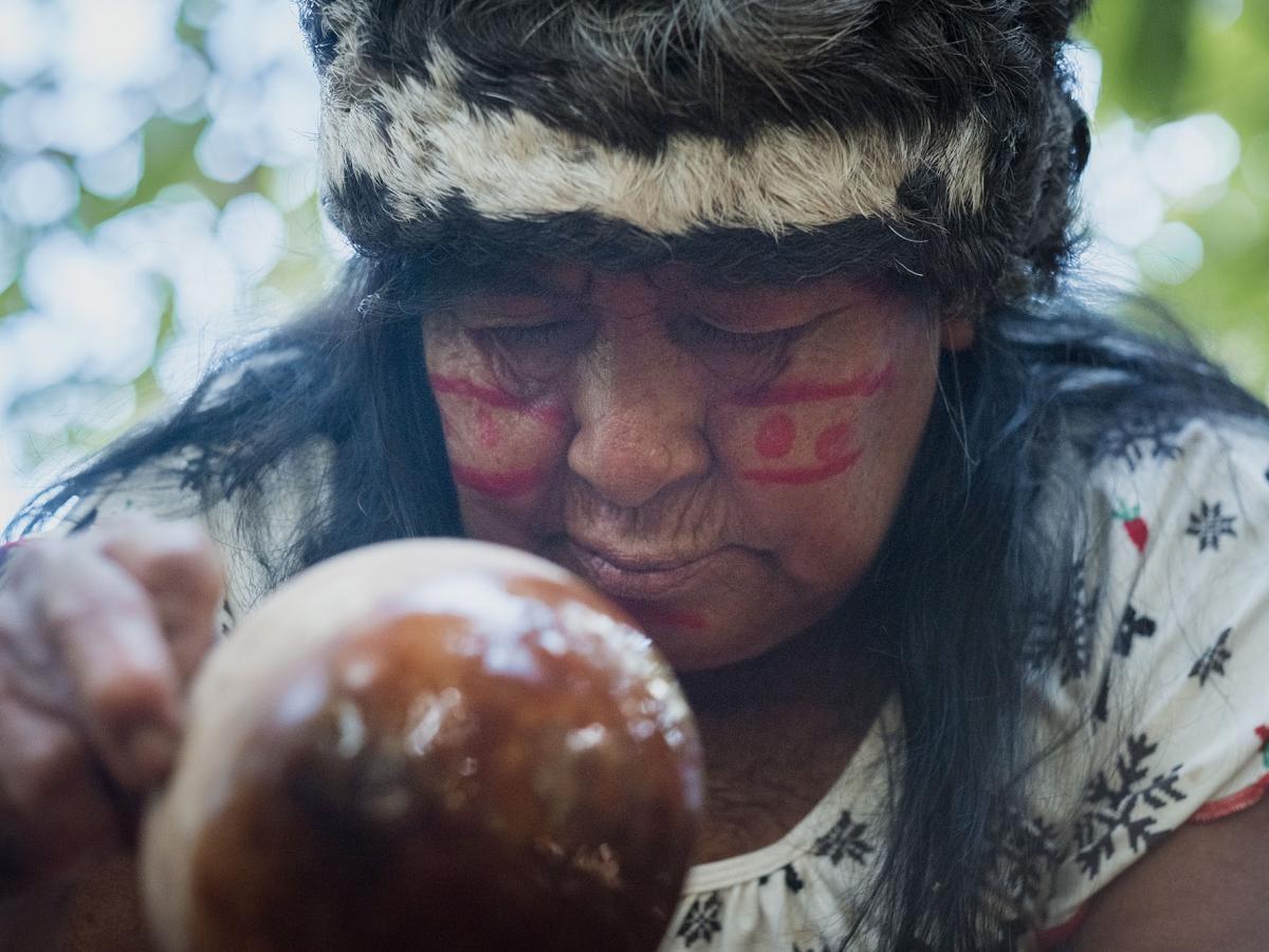 An indigenous woman preparing beverage