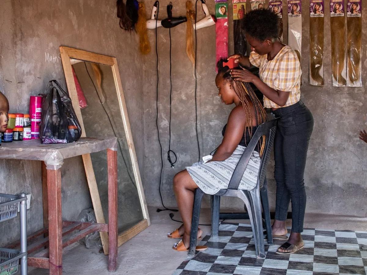 Mapesho provides hair styling services at her salon. / Credit: Center for Infectious Disease Research in Zambia