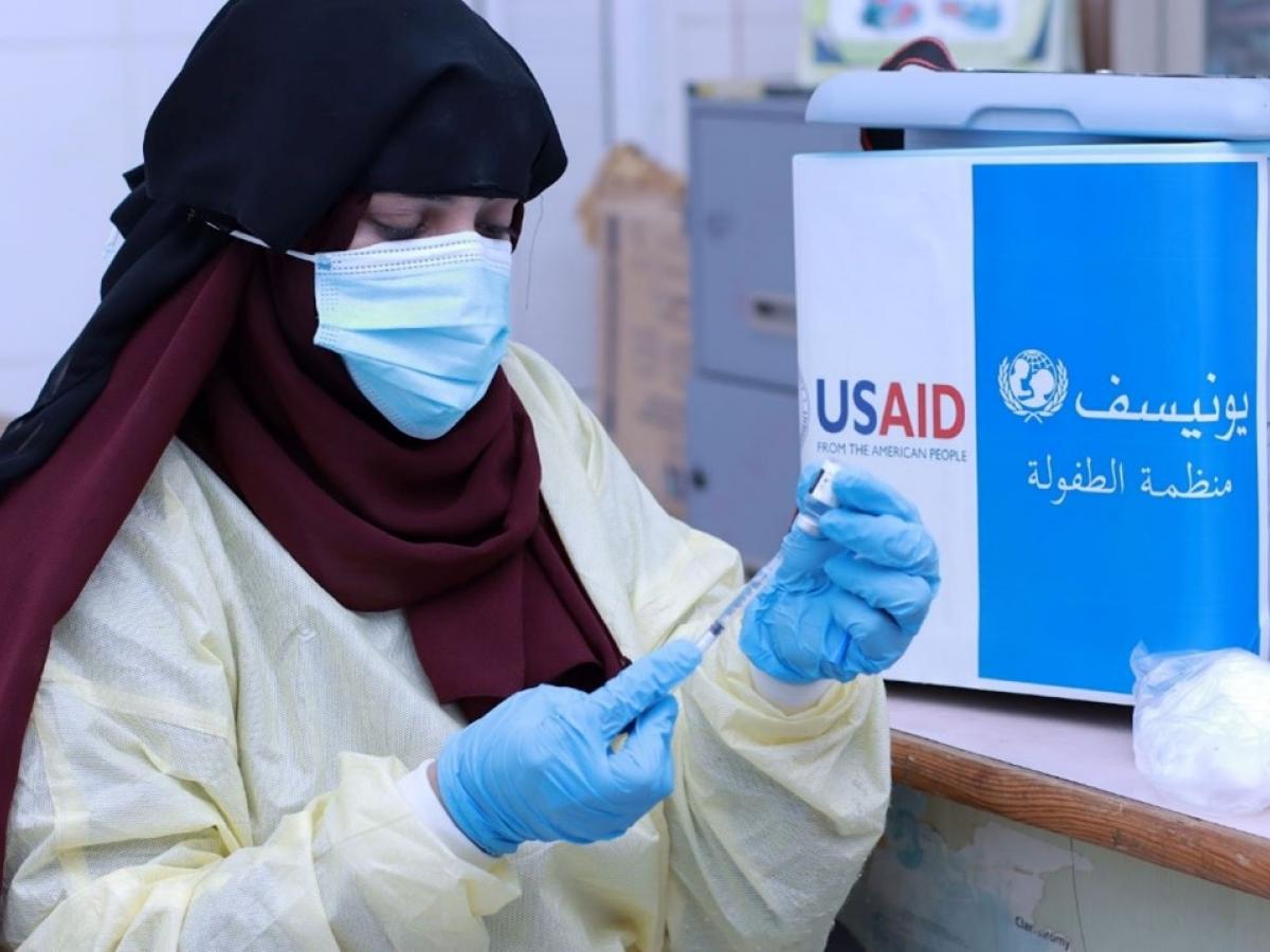 A health worker prepares a COVID-19 vaccine donated with U.S. government funding.