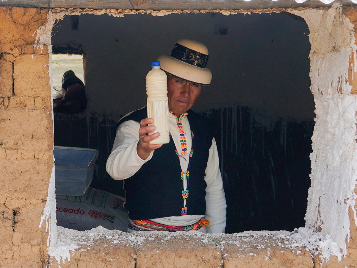 Genaro Criollo showing a bottle of artisanal yogurt