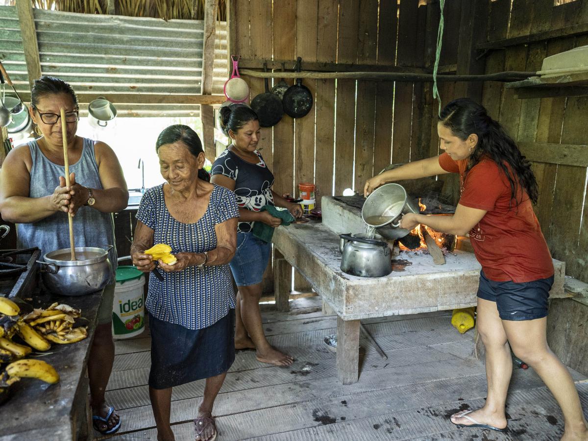 Yacxeri and three woman of their family cooking in the kitchen