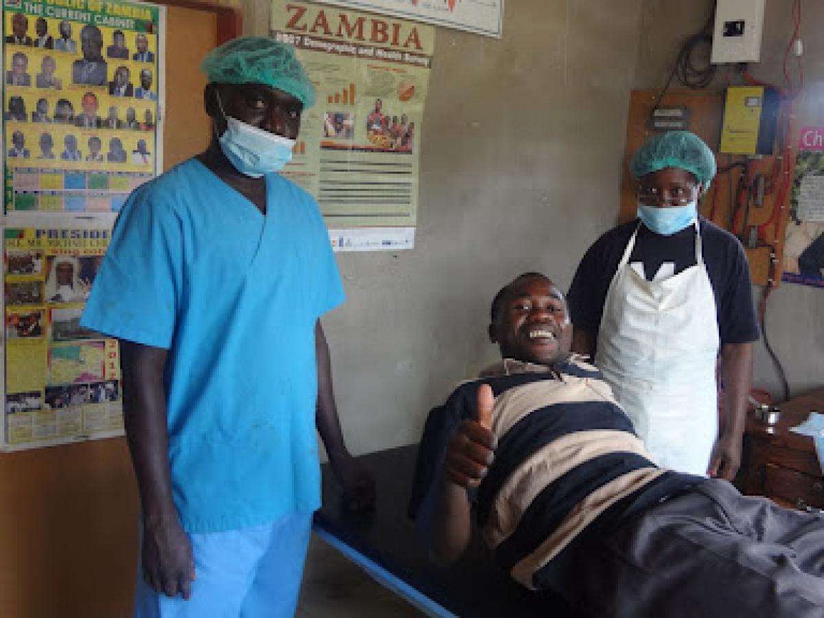Caption: A man right after being circumcised by Society for Family Health service providers following a SHARe II-sponsored VMMC demand-creation event in Cooma Chiefdom; he led by example by being the first from his village to be circumcised. Project: Support to the HIV/AIDS Response in Zambia II (SHARe II)