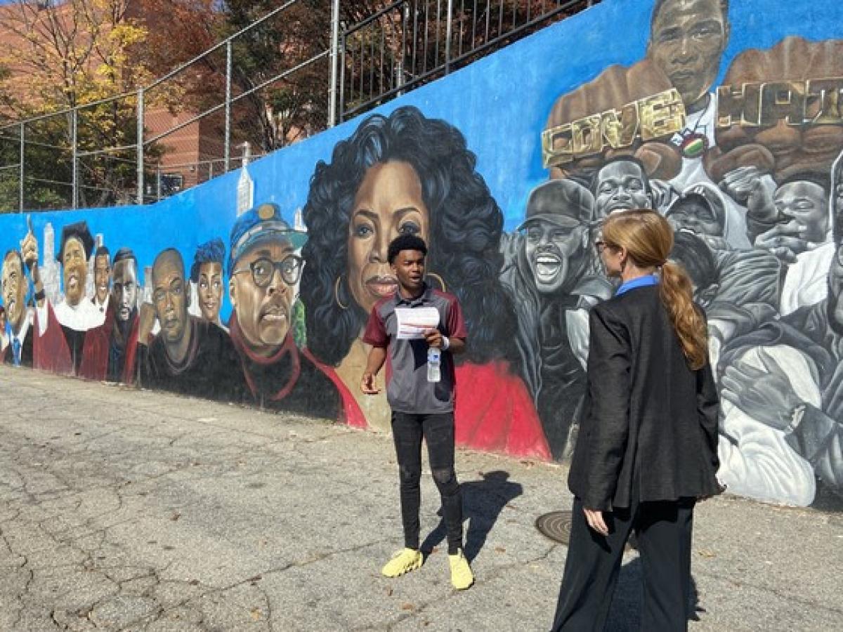 Administrator Samantha Power walking by a mural during a visit to Morehouse College in Atlanta